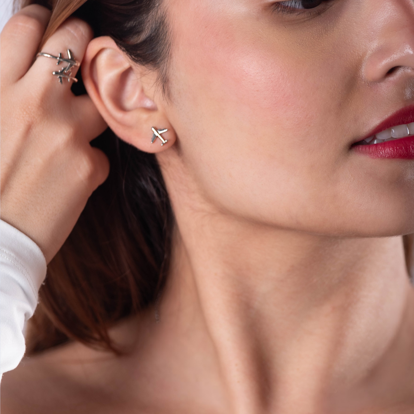 Travel-inspired earrings crafted from sterling silver. Each earring showcases a tiny airplane charm size 10mm, ideal for the adventurous spirit.