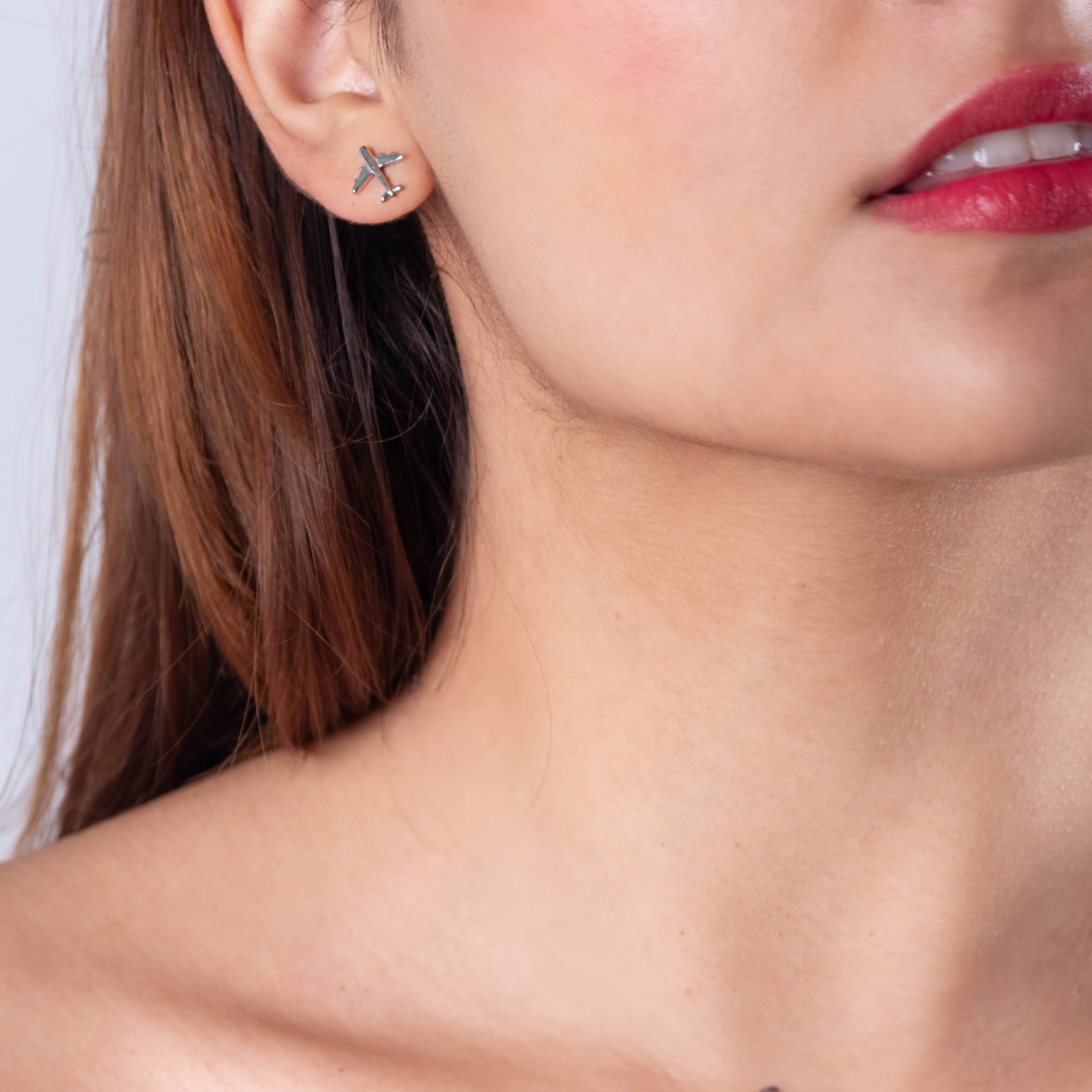 Sterling silver earrings featuring delicate airplane charm, approximately 10mm in size. A must-have for frequent flyers and travel enthusiasts.